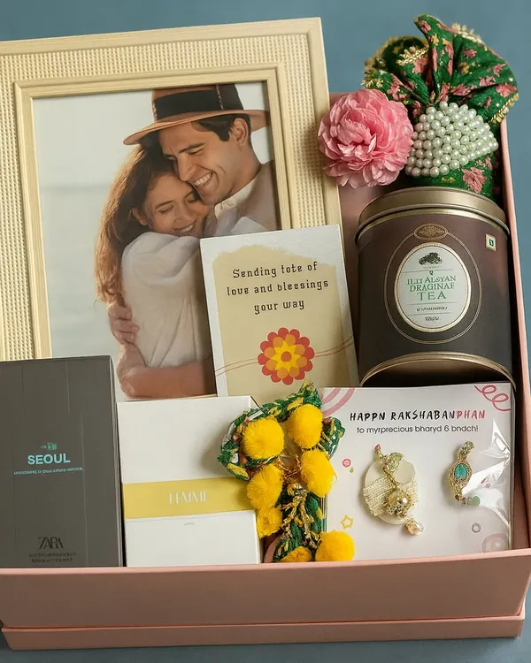 Celebrating the special bond between Bhaiya and Bhabhi with this beautiful Rakhi hamper. It includes a photo frame, matching perfumes, a lumba rakhi set, and masala chai.