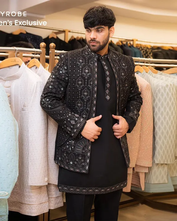 This is the look that turns heads. A modern black Indo-western jacket with intricate embroidery, paired with a matching kurta, shows how we blend tradition with contemporary style. It's a perfect statement piece for a reception or sangeet.