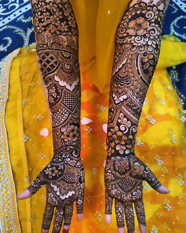 A full bridal henna set for a beautiful bride on her big day. The design features a mix of traditional motifs that flow from her hands all the way up her arms.