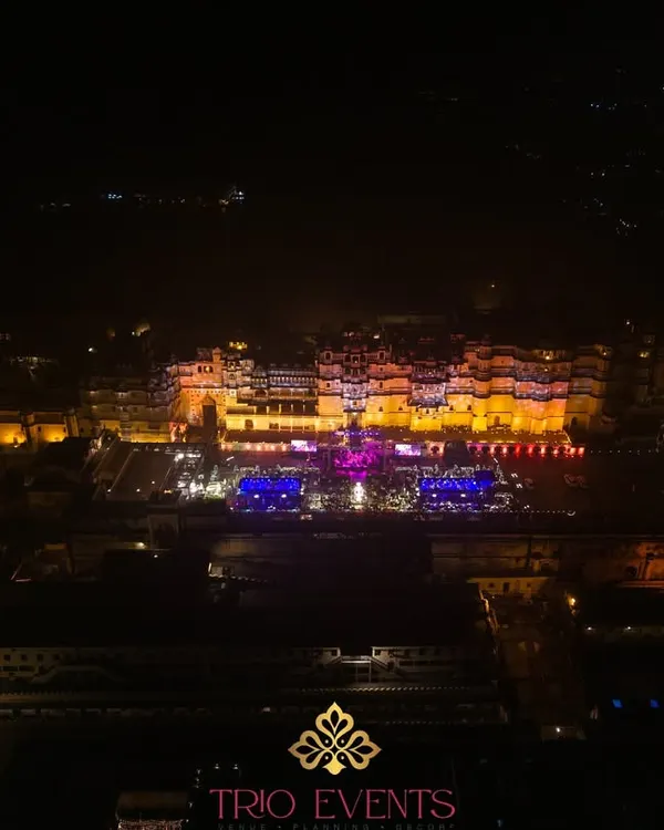 A stunning drone shot showcasing the sheer scale and grandeur of the City Palace complex in Udaipur during a wedding celebration. I have extensive experience managing events at this premier heritage venue.