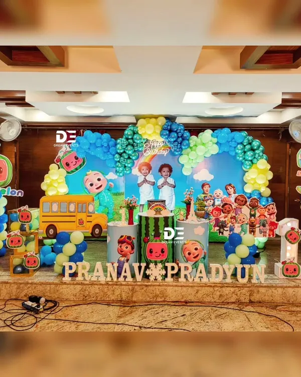 A fantastic Cocomelon party for twins Pranav and Pradyun. This setup features the iconic school bus, JJ, and all their friends, with a bright and colorful balloon arch to complete the scene.