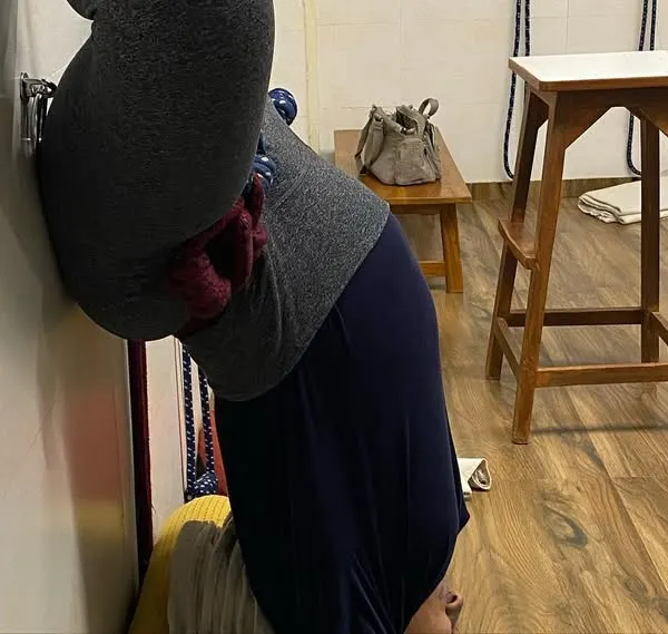 I offer prenatal yoga classes. Here, a pregnant student is in a modified headstand against the wall, which is safe and beneficial for relieving back pressure.