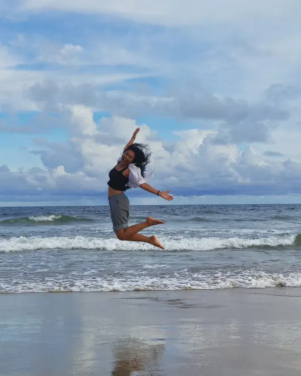 A moment of pure joy, jumping on the beach. This candid lifestyle shot captures my energetic and free-spirited personality, perfect for travel and wellness brands.