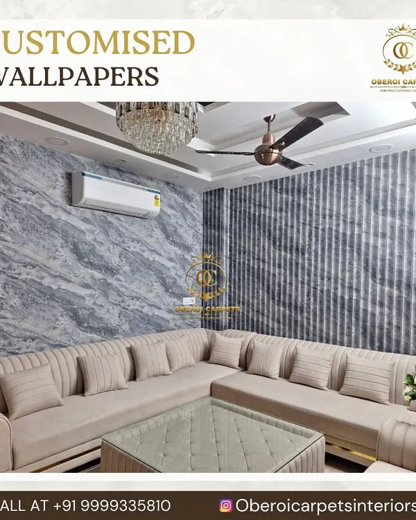 This living room features a combination of two different wall treatments. One wall has a custom wallpaper with a grey marble texture, while the accent wall uses a vertically striped wallpaper, creating a sophisticated and layered interior design.