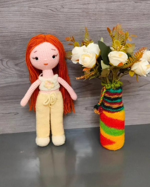 This is a beautiful crochet doll I made with long red hair. Her top and pants can be removed, which makes her fun for children to play with.