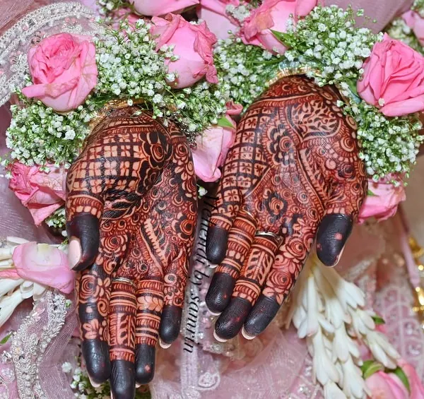 The perfect rich maroon stain against a backdrop of fresh flowers. This is the result of my organic henna and proper aftercare.