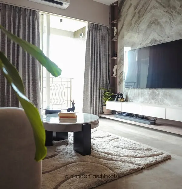 This living room in our Sai World Empire project embodies quiet luxury. The marble-clad TV wall serves as a stunning focal point, balanced by soft furnishings and warm, layered lighting for a cozy yet sophisticated feel.