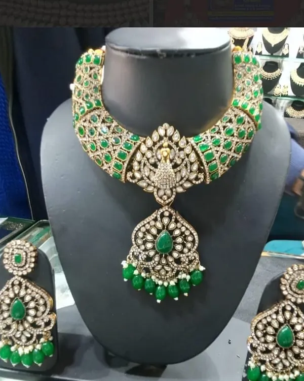 This grand bridal necklace set is one of my finest pieces, featuring intricate kundan work with a beautiful peacock pendant. The rich green stones and American diamonds give it a royal look, perfect for a bride or for any grand celebration.