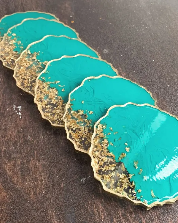 A set of stunning teal and gold resin coasters. I'll teach you how to create this geode-inspired look with a beautiful gold leaf edge.