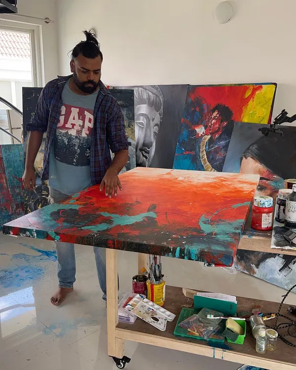In my studio, working on 'The Uprising', a 5x3 feet abstract. This is where the magic happens, surrounded by paints, canvases, and inspiration.