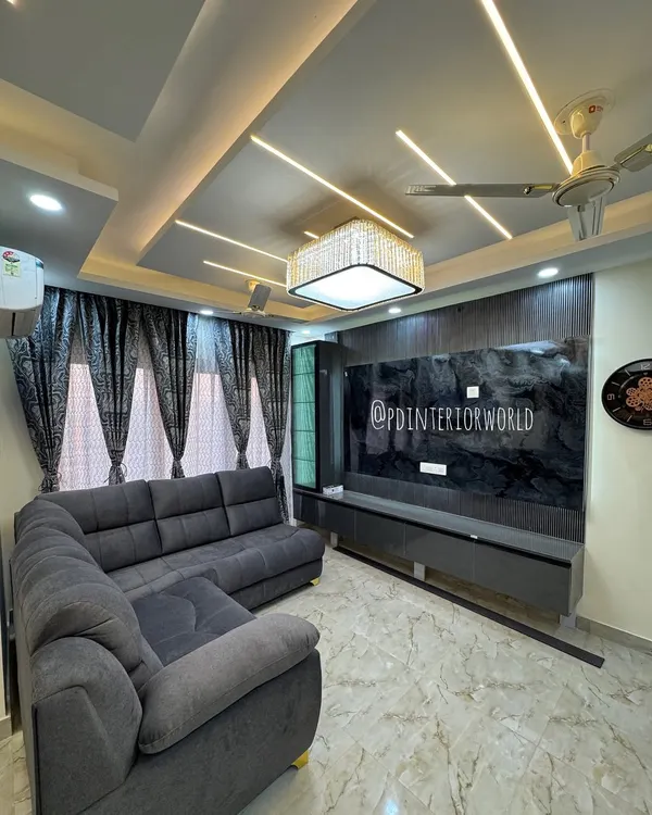 This is what a complete transformation looks like. For this drawing room, I designed a modern false ceiling with integrated profile lights and a statement crystal chandelier, creating a luxurious and welcoming atmosphere.