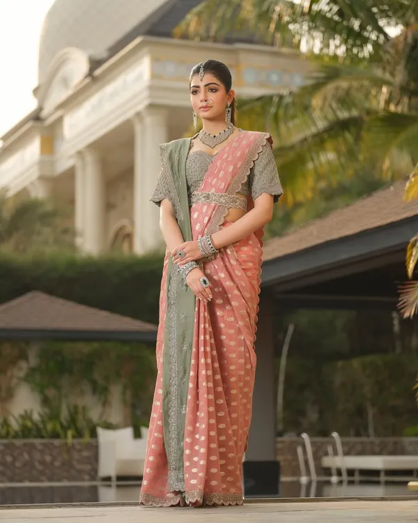 The ethereal allure of a Jayanti Reddy saree. The combination of dusty pink and sage green, paired with traditional jewellery, creates a look of quiet, sophisticated elegance.