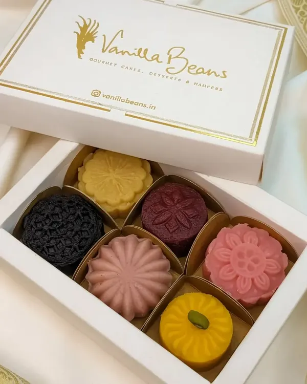Our assorted Cake Mithai box, showcasing the intricate designs and vibrant colors of our fusion desserts. A perfect gift for Diwali or any celebration.