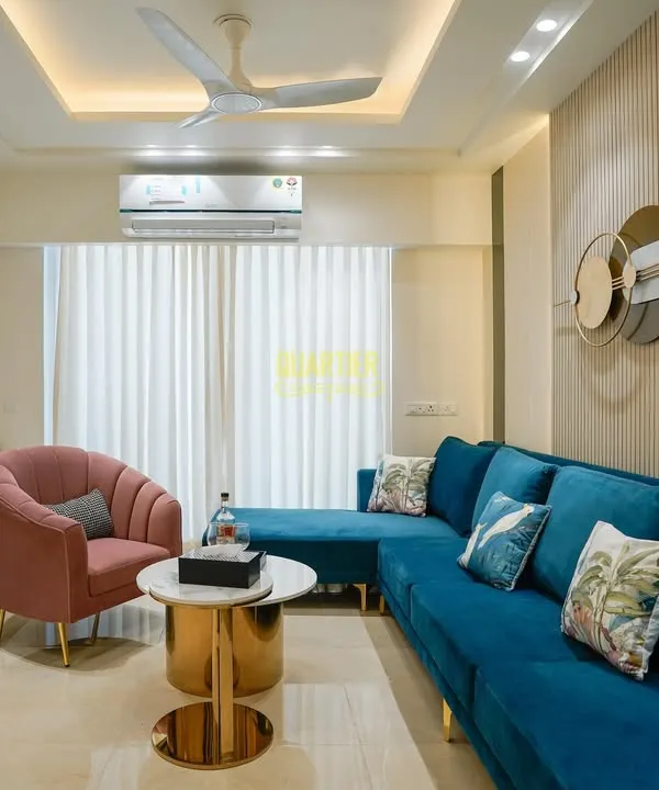 This living area in Gurugram is a sanctuary of modern luxury. I designed this space to be both sophisticated and comfortable, using a rich color palette with a vibrant teal sofa, elegant fluted wall panels, and statement gold accents to create a curated experience for daily living.