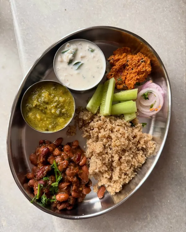 This is what healthy eating looks like for me: a balanced, delicious, and satisfying Indian meal. My coaching is built on the belief that you don't have to give up your favorite foods like this quinoa `oota` with rajma, banana stem raita, and fresh veggies to reach your health goals. I'll show you how to nourish your body with the food you love.
