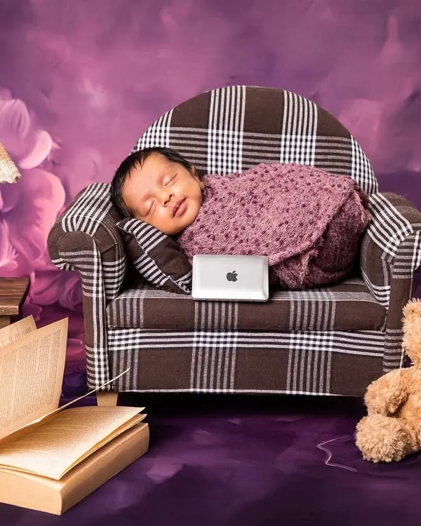 Meet the new boss. This playful "Boss Baby" theme features a newborn sleeping on a miniature plaid sofa with a tiny laptop, ready to take over the world one nap at a time.