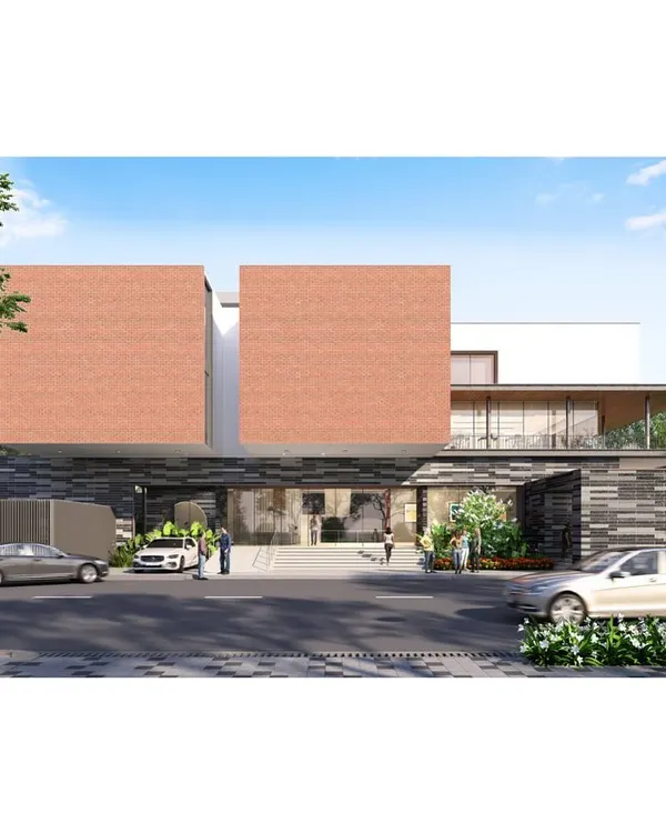 A daytime visualization of a luxury clubhouse for a 7.1-acre residential community in Bengaluru. The facade combines bold, solid brick volumes with a transparent, welcoming ground floor, clearly defining the public and private zones within the building.