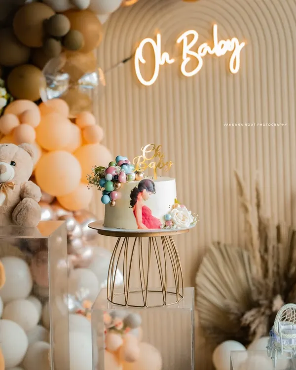 A beautifully styled baby shower cake and decor setup, featuring a boho theme with balloons and a neon 'Oh Baby' sign. I capture the aesthetic of your event to complete the story.