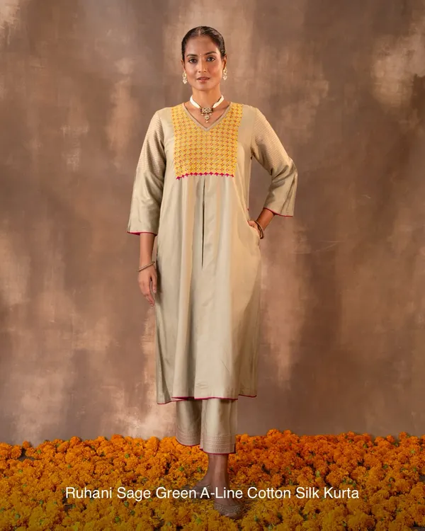 The Ruhani Sage Green A-Line Kurta, shown here in its full length. Crafted in a rich cotton-silk blend with Pakka hand embroidery, it offers a balance of comfort and quiet sophistication, complete with side pockets for practicality.