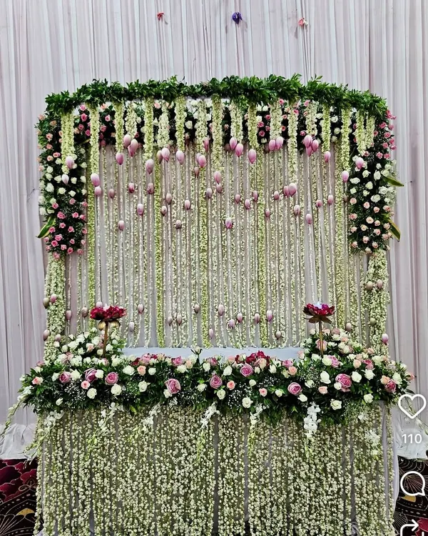 For a truly breathtaking effect, I designed this magnificent mandap featuring a curtain of thousands of fresh jasmine (mogra) strings. The setup is framed with delicate pink and white flowers, creating a fragrant and visually stunning throne for Bappa.