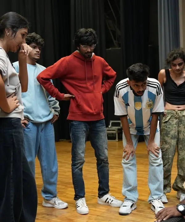 This is where the magic begins. An instructor gives detailed feedback to a group of dancers during a rehearsal for Performance Night.