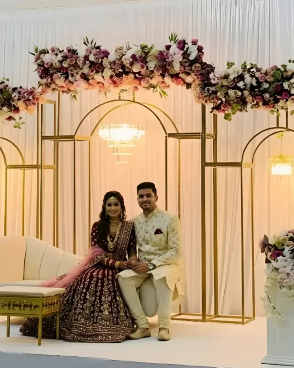 This is what it's all about: creating a beautiful backdrop for your most cherished moments. For this engagement, I designed a modern stage with clean golden arches, a cascade of mauve and white florals, and elegant lighting. The couple's joy brings the whole scene to life, creating a perfect photo opportunity that they will look back on for years.
