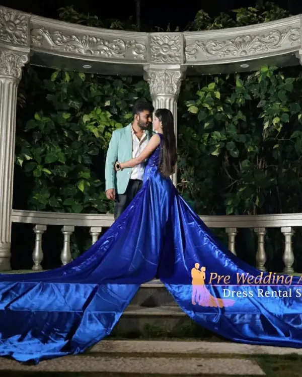 This is my signature flying gown in a stunning royal blue satin. The extra-long, lightweight tail spreads out beautifully for dramatic shots, especially for night photography with romantic lighting. The couple's pose here shows how the gown makes a statement while keeping the focus on you.