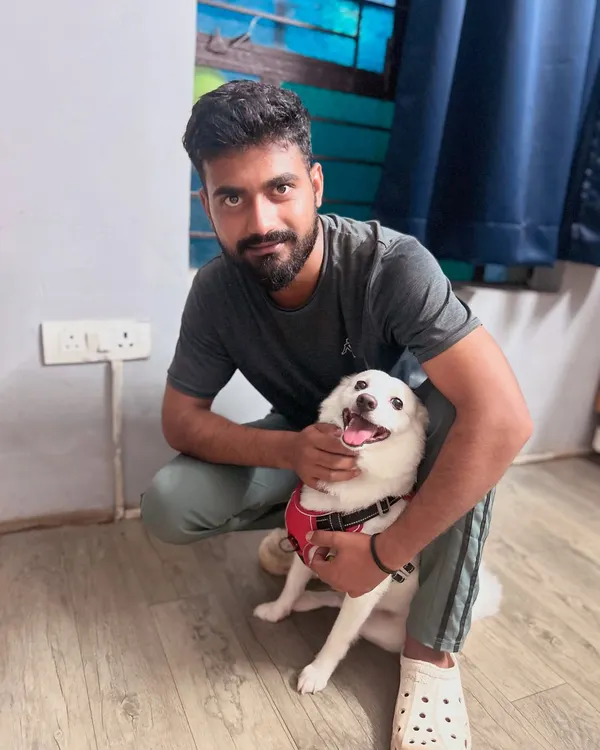 Our staff member Guddan sharing a cuddle with the birthday boy, Bunni. Our team doesn't just care for the dogs; they form genuine, loving bonds with each one.