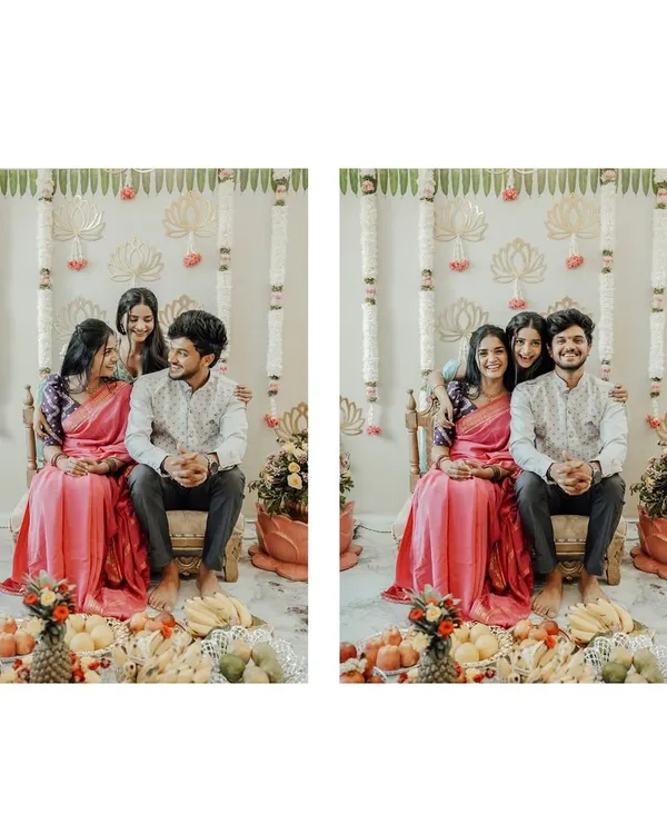 A lovely family portrait from a traditional ceremony. The backdrop features simple, elegant decor with hanging lotus motifs and floral strings, creating a serene and beautiful setting.