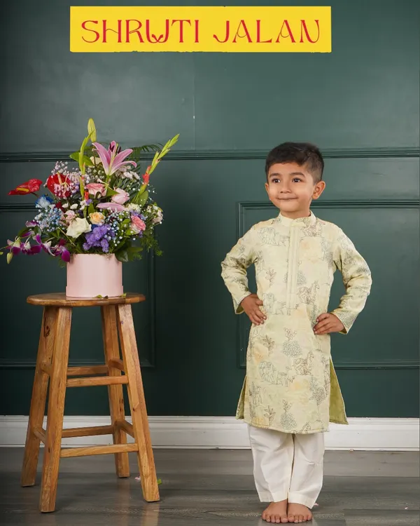 Little man, big style. This little boy looks dapper and ready for any event in a pale green printed kurta set.