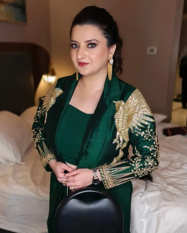 A powerful and glamorous look perfect for a cocktail party or reception. The emerald green outfit is complemented by a sharp, defined eye makeup look and a sleek, pulled-back hairstyle.