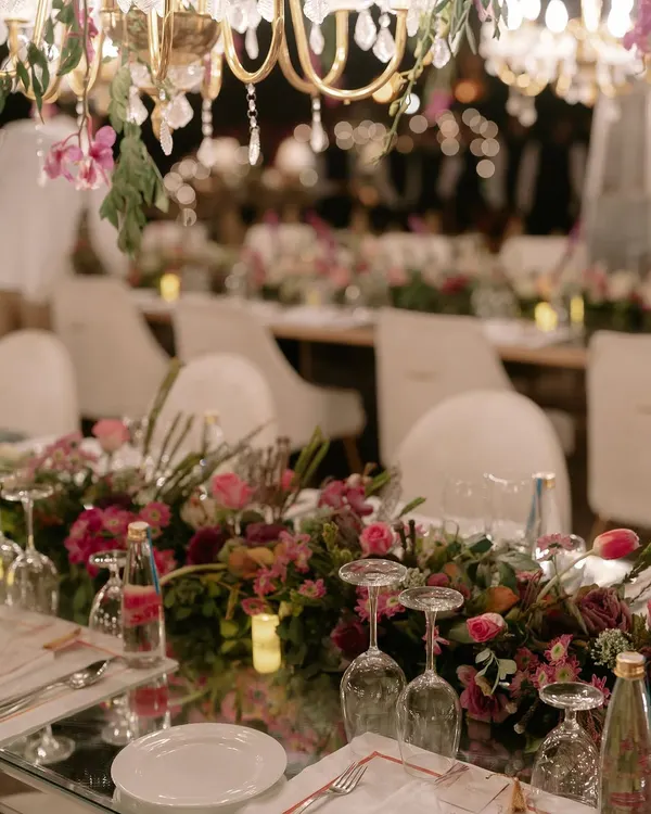 A close-up of the tablescape for Kahran and Gourav's finale dinner. We used mirrored tabletops to reflect the hundreds of chandeliers and floral arrangements above, creating an endless, magical glow for the evening.