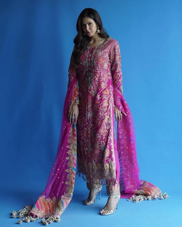 For me, this is Punjab di shaan. I styled this vibrant pink Punjabi suit to highlight the intricate, traditional embroidery while ensuring the fit and drape felt modern and powerful. The bold blue background makes the colors pop.