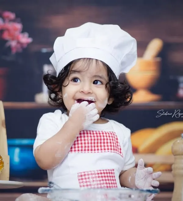 The best part of being a chef is tasting the ingredients. This little one couldn't resist a taste of flour, making for an adorable and funny shot.