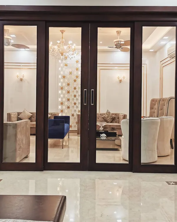 The view into the living room of Villa 9/21B is framed by custom-made wooden and glass doors. This composition highlights our focus on creating layers and depth in our interior architecture, turning a simple doorway into a design feature.