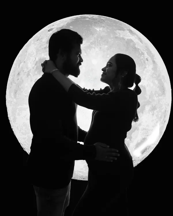 A romantic couple's silhouette against my signature moon backdrop. This is one of my personal favorite styles for creating dramatic and unforgettable maternity portraits.