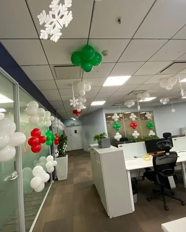 Getting this office in the festive spirit with Christmas themed balloon decorations and snowflake cutouts hanging from the ceiling.