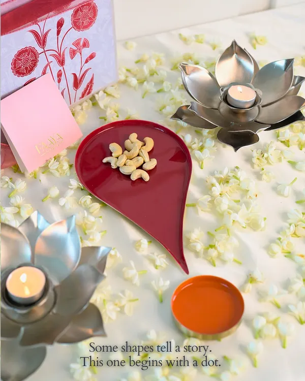 Some shapes tell a story. This one begins with a dot. Our Bindu plate, shaped like the symbol of beginnings, is shown here holding cashews, next to lotus-shaped diyas. It’s a piece designed to bring meaning to your festive moments.