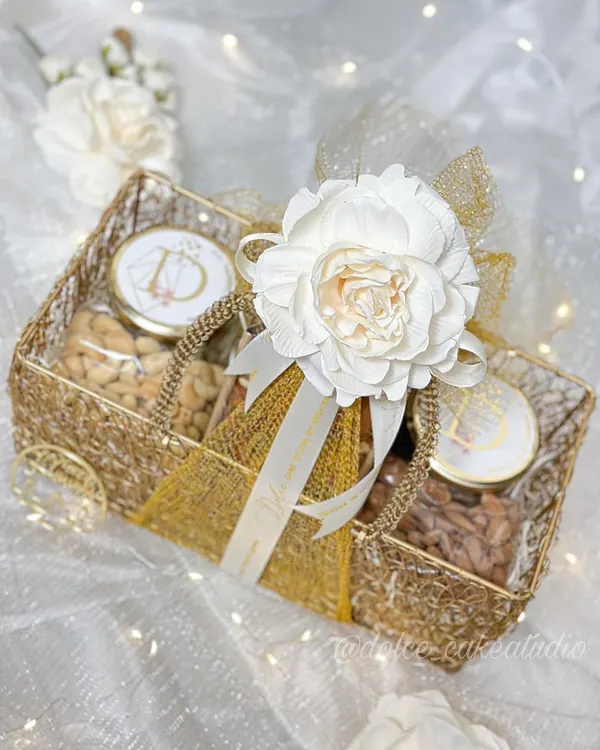 This beautiful mesh basket hamper is one of my signature Diwali gifts. It’s filled with a mix of my handmade, eggless tea cakes and jars of savory roasted nuts, all packed with care and decorated with a reusable flower. It’s a perfect, complete gift for the festive season.