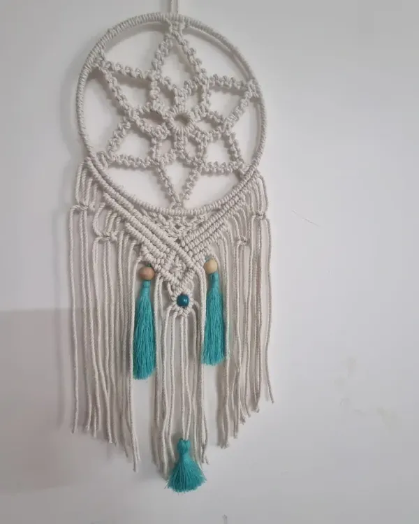 This full view of my macrame dreamcatcher shows the intricate star pattern and delicate tassels. It's a beautiful piece to hang above a bed or in a living room to catch good dreams and add a peaceful vibe.