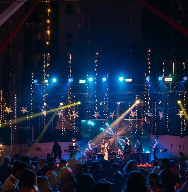 The stage is set for a massive Christmas party. The festive lights and decorations create a magical atmosphere for a night of live music and dancing.