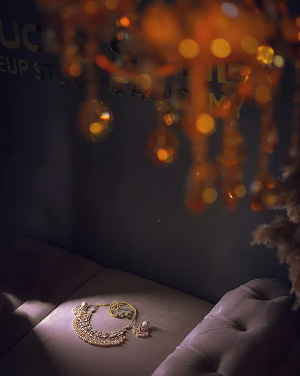 An artistic shot of the bride's necklace and earrings, laid out before she gets ready. The lighting and composition make this a beautiful detail photo.