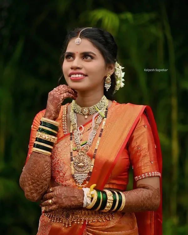 A picture perfect Maharashtrian bride. I draped her rich orange silk saree to highlight its intricate border and ensure she looked and felt her absolute best for her wedding photography.