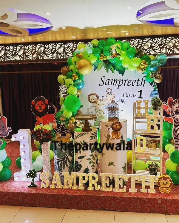 This is one of my favorite setups, a full Jungle Safari theme for a first birthday! I bring in everything from the leafy green balloon arch and animal cutouts to the themed pedestals and light-up name signs to make your little one's "Wild One" party unforgettable.