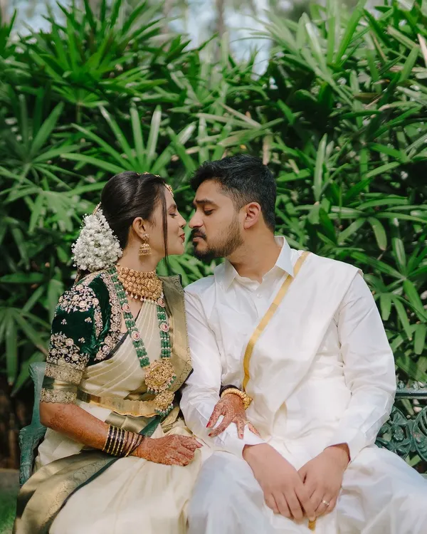 A quiet moment between a couple, captured in a lush garden setting. We focus on the near-kiss and gentle touch to create a feeling of intimacy and romance.