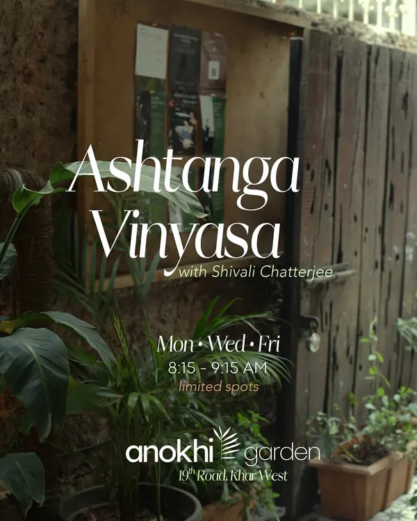 The rustic wooden entrance to Anokhi Garden, surrounded by lush greenery. This image captures the essence of our space as a hidden oasis in the heart of Khar West.