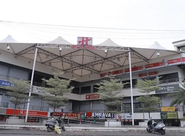 The completed 'Ayur Mall' in Amravati, a growing tier-three city. We solved the challenge of a triangular plot by creating two frontages, ensuring every shop has maximum visibility and access, which is crucial for commercial success.