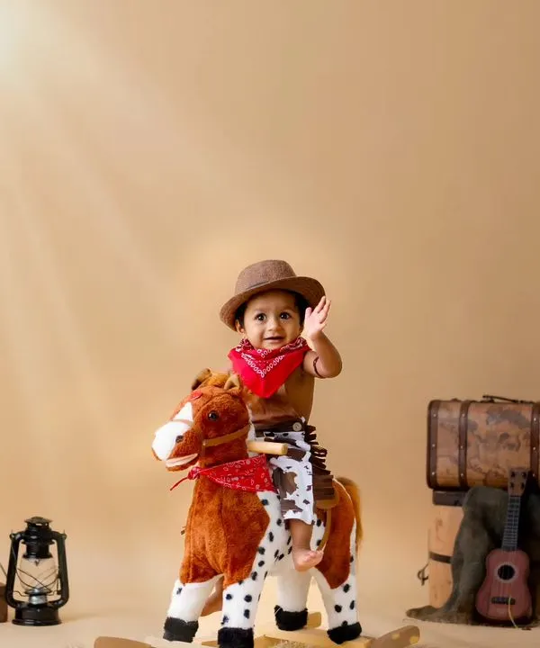 This little cowboy is ready to ride! The rocking horse and vintage luggage create a perfect wild west scene right in my studio.