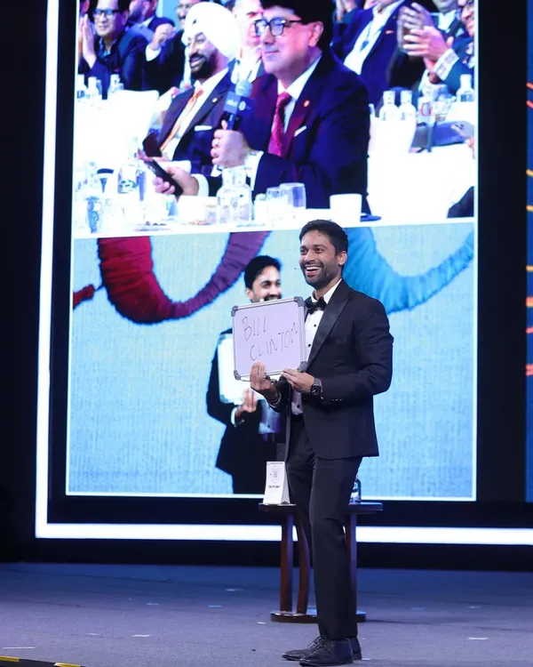 The big reveal during a mind-reading act for the leaders at Taj Hotels. You can see the audience's reaction on the top screen as I show that I knew the name they were thinking of. It’s a powerful moment that connects with the entire room.