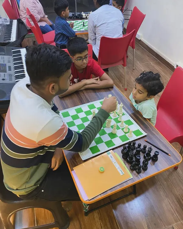 Even our youngest students are captivated by the game of chess. Here, an instructor guides a game, showing how we provide personalized coaching to players of all ages and skill levels.